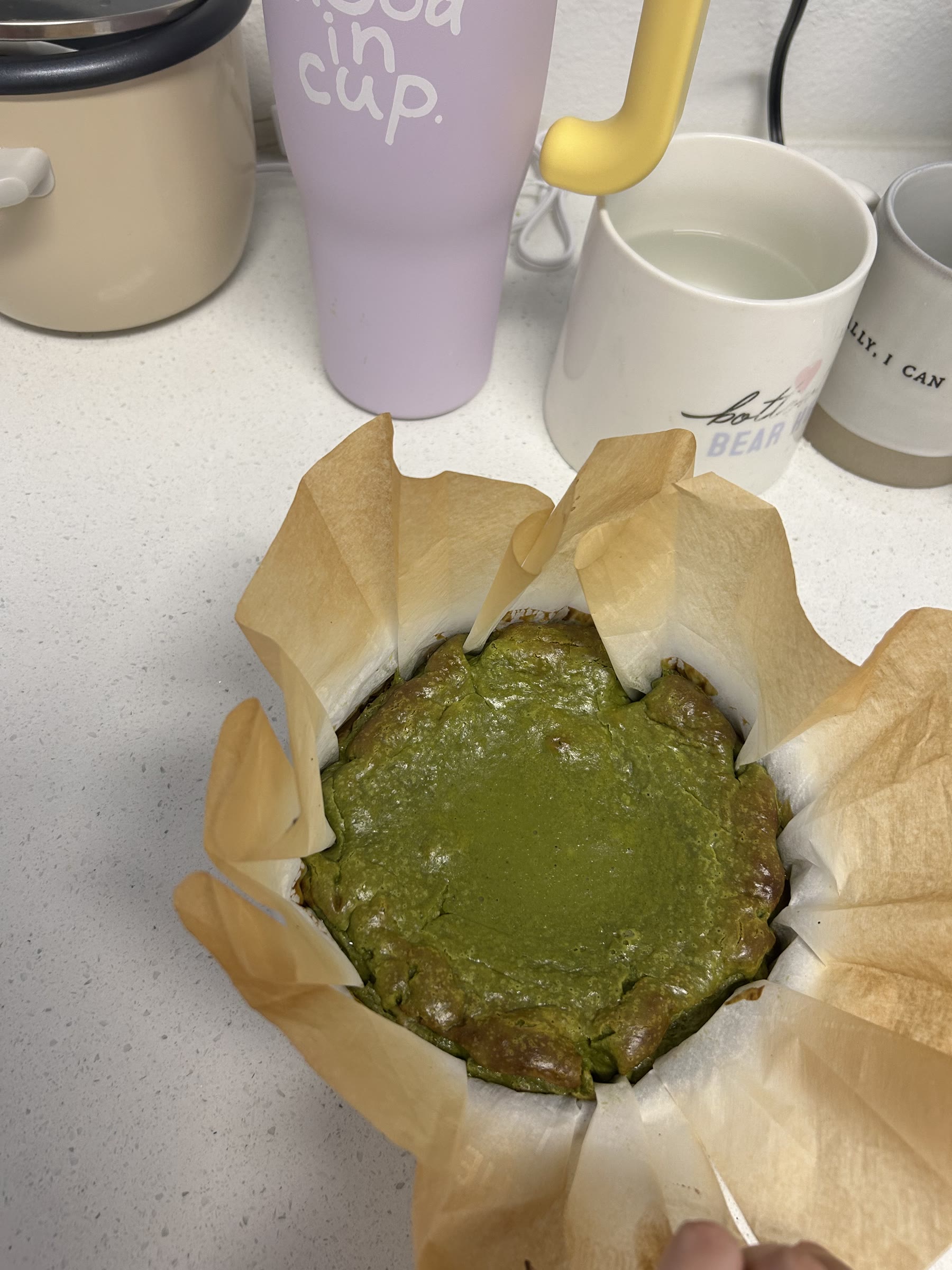A matcha Basque cheesecake baking in parchment paper
