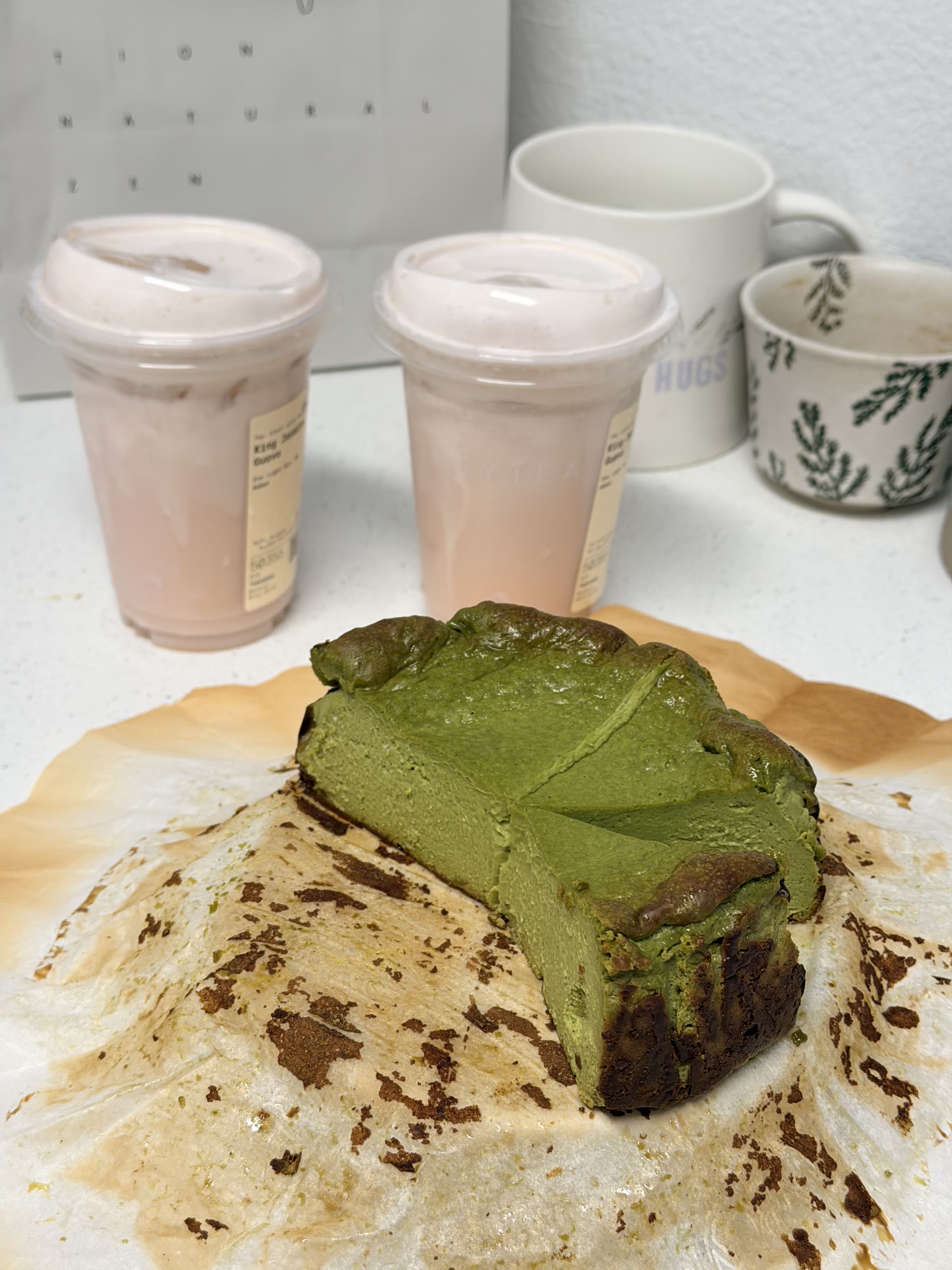 A finished matcha Basque cheesecake with a slice cut out