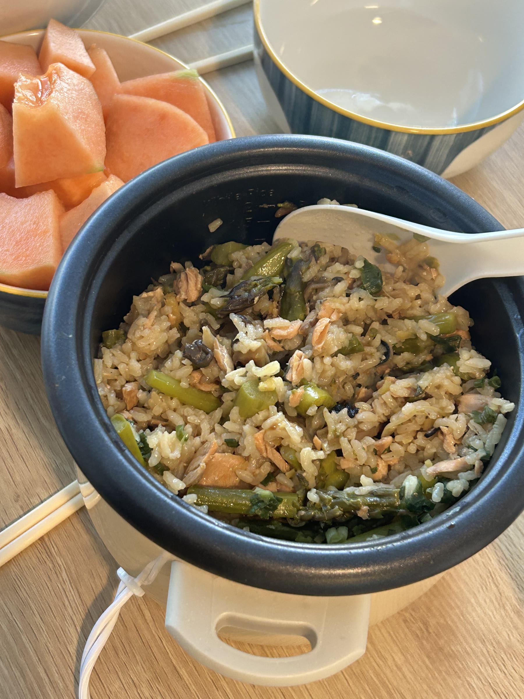 Salmon and asparagus rice served with papaya